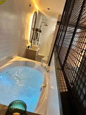 a large bath tub with blue water in it at Luxury penthouse with Jacuzzi and AC, North Medellin in Medellín