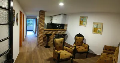 a living room with two chairs and a fireplace at Cabaña en la CRISTALINA San Rafael embrujo de aguas cristalinaa in San Rafael