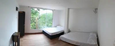 a bedroom with two beds and a window at Cabaña en la CRISTALINA San Rafael embrujo de aguas cristalinaa in San Rafael