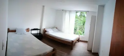 a small room with two beds and a window at Cabaña en la CRISTALINA San Rafael embrujo de aguas cristalinaa in San Rafael