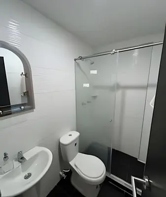 a bathroom with a toilet and a sink and a shower at Casa Acogedora y Amplia - Estrato 5 in Manizales