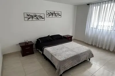 a bedroom with a bed and a window at Casa Acogedora y Amplia - Estrato 5 in Manizales