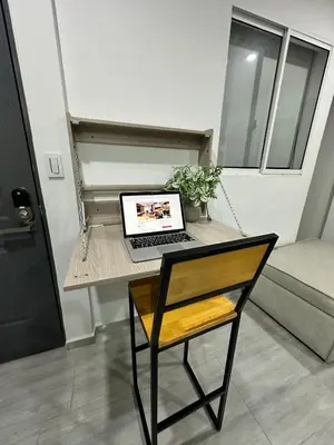a laptop computer sitting on a desk in a room at Charming scape cozy and stylish N Medellin in Medellín