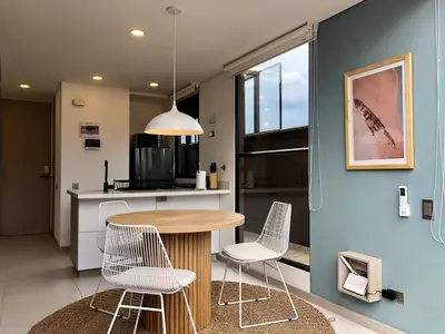 a kitchen and dining room with a table and chairs at Cozy Studio in Laureles MDE in Medellín