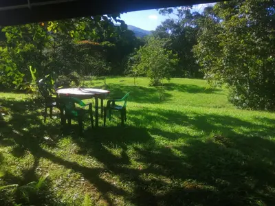 a table and chairs in a field of grass at Cabin with River in San Rafael