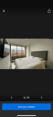 a television screen showing a bedroom with a bed and a window at Casashots in Medellín
