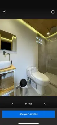 a bathroom with a white toilet and a sink at Casashots in Medellín