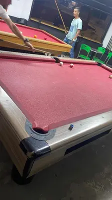 two men playing a game of pool on a pool table at Casashots in Medellín