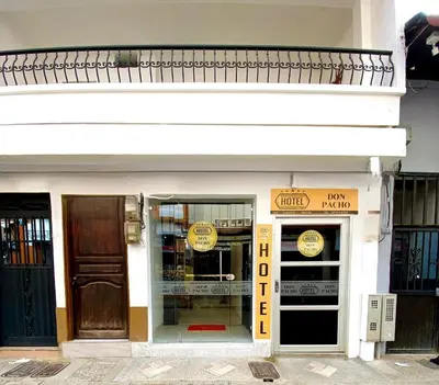a store front of a building with signs on it at Hotel Don Pacho in Los Andes