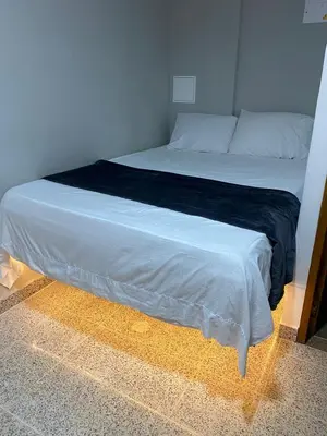 a bedroom with a large bed with a black blanket at Hotel Don Pacho in Los Andes