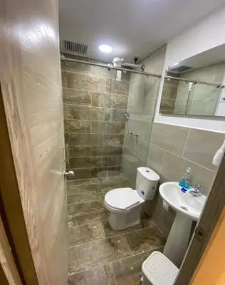 a bathroom with a toilet and a sink at Hotel Don Pacho in Los Andes