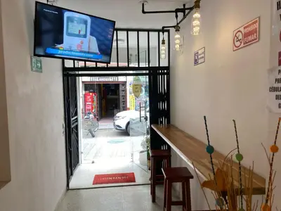 a flat screen tv on the wall of a building at Hotel Don Pacho in Los Andes