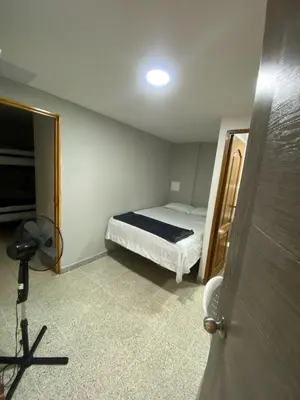 a small bedroom with a bed and a mirror at Hotel Don Pacho in Los Andes