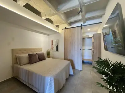 a bedroom with a large bed in a room at Apartaestudio en el Corazón del Oriente Antioqueño in La Ceja