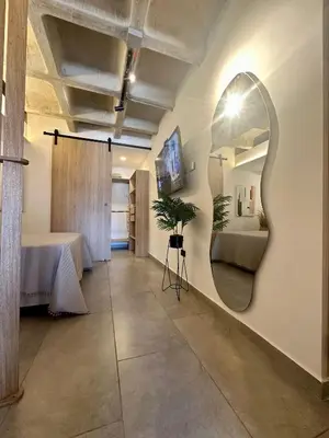 a room with a mirror on the wall with a bed at Apartaestudio en el Corazón del Oriente Antioqueño in La Ceja