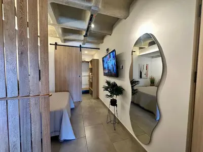 a room with a mirror and a table and a bed at Apartaestudio en el Corazón del Oriente Antioqueño in La Ceja