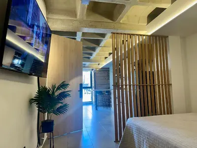 a room with a bed and a potted plant at Apartaestudio en el Corazón del Oriente Antioqueño in La Ceja