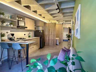 a kitchen and living room with a couch and a table at Apartaestudio en el Corazón del Oriente Antioqueño in La Ceja