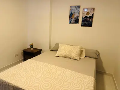 a small bedroom with a bed with a pillow at Gran loft cerca al tesoro y al lleras 121 in Medellín
