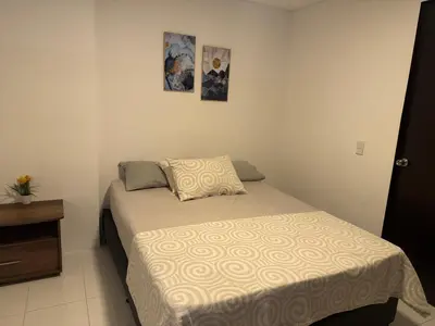 a small bedroom with a bed and a dresser at Gran loft cerca al tesoro y al lleras 121 in Medellín