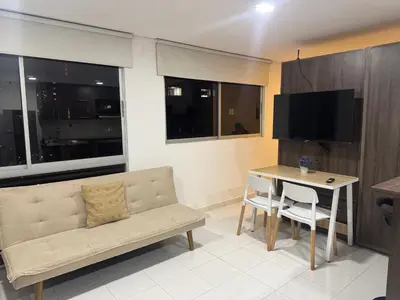 a living room with a couch and a table at Gran loft cerca al tesoro y al lleras 121 in Medellín