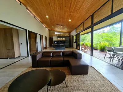 a living room with a couch and a table at Los Pinos in Guatapé