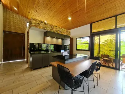 a kitchen with a large wooden table and chairs at Los Pinos in Guatapé