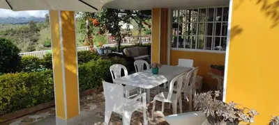a white table and chairs on a patio at Finca Con Hermosa Vista a la Piedra del Peñol y Jacuzzi Grande in El Peñol