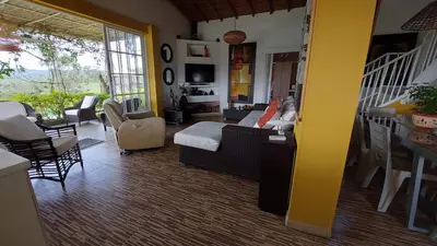 a living room with a couch and a table at Finca Con Hermosa Vista a la Piedra del Peñol y Jacuzzi Grande in El Peñol