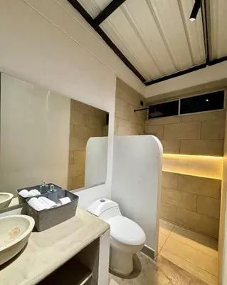 a bathroom with a toilet and a sink at Villa Entre Nubes in El Hatillo