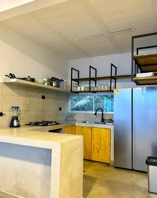 a kitchen with a stainless steel refrigerator and wooden cabinets at Villa Entre Nubes in El Hatillo