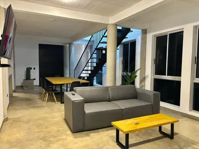 a living room with a couch and a table at Villa Entre Nubes in El Hatillo