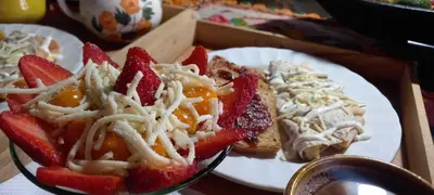 a white plate of food with strawberries and cheese at Bohemio Chic House - Alojamiento con vista al bosque a 45 minutos de Medellin en Santa Elena in Santa Elena