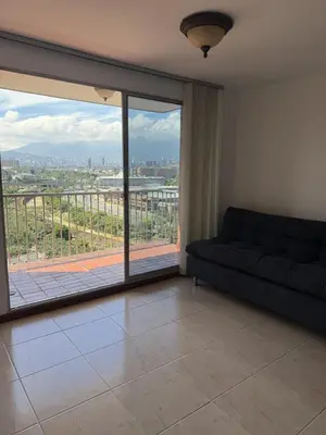 a living room with a couch and a large window at Apartment in Poblado 17th Floor W Pool in Medellín