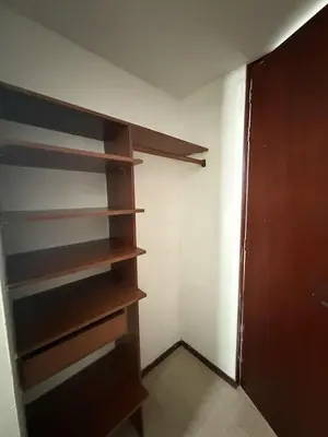 a closet with wooden shelves in a room at Apartment in Poblado 17th Floor W Pool in Medellín