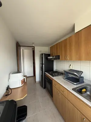 a kitchen with a black refrigerator and a sink at Apartment in Poblado 17th Floor W Pool in Medellín