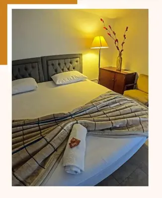 a bedroom with a large bed with a towel on it at Hotel Marinilla Oriente in Marinilla
