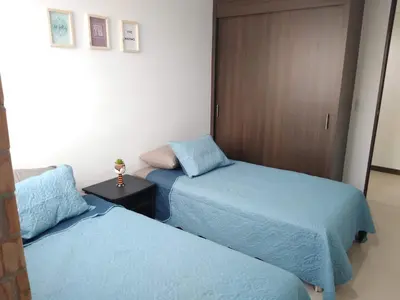 two beds sitting next to each other in a room at Confortable Apartamento, Sabaneta in Sabaneta