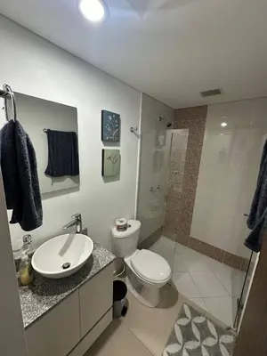 a bathroom with a toilet and a sink and a shower at Confortable Apartamento, Sabaneta in Sabaneta