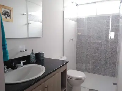 a bathroom with a sink and a toilet and a shower at Confortable Apartamento, Sabaneta in Sabaneta
