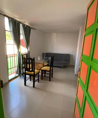 a living room with a table and chairs and a couch at Apartamento cómodo y tranquilo cerca al parque principal de Guatapé in Guatapé