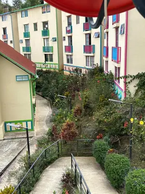 an apartment building with colorful balconies and stairs in front at Apartamento cómodo y tranquilo cerca al parque principal de Guatapé in Guatapé