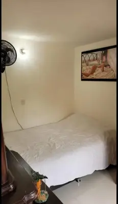 a bedroom with a bed and a picture on the wall at Apartamento Vacacional in San Carlos Antioquia in San Carlos