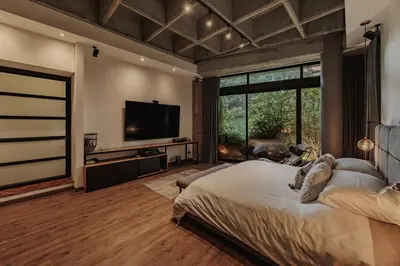 a bedroom with a large bed and a television at Designer Loft, Unique location, Provenza, Lleras in Medellín