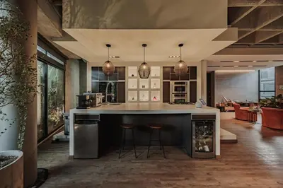 a kitchen with a large island with bar stools at Designer Loft, Unique location, Provenza, Lleras in Medellín