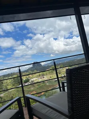 a balcony with a table and chairs and a view at Althuum House in Chiquinquirá