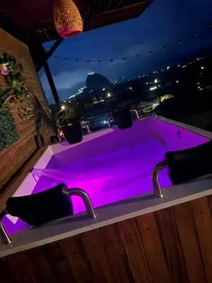 a hot tub with purple lighting in a backyard at Althuum House in Chiquinquirá