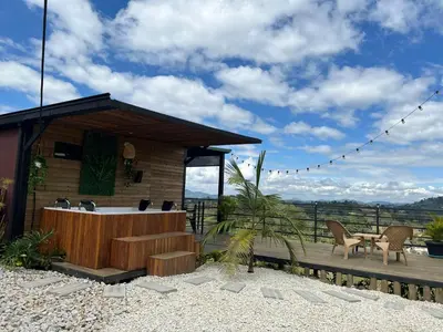 a house with a deck with a table and chairs at Althuum House in Chiquinquirá