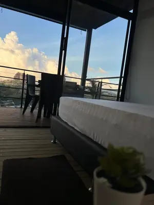 a balcony with a table and chairs on a boat at Althuum House in Chiquinquirá