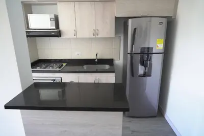 a kitchen with a refrigerator and a sink at Apartamento Las Vegas Plaza in Sabaneta